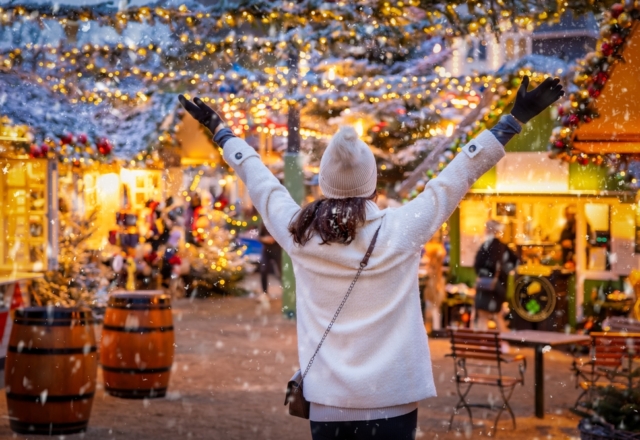 A,Happy,Tourist,Woman,Stands,On,A,Christmas,Market,In